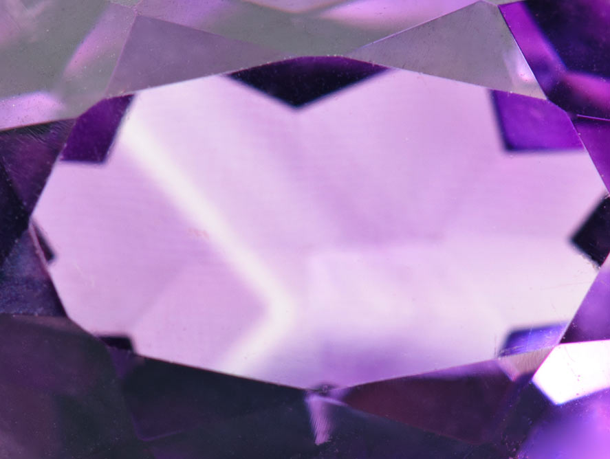 Angular color-zoning observed within a faceted amethyst gem