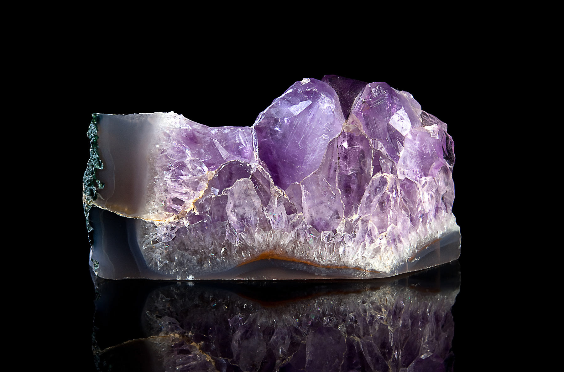 A raw amethyst cluster showing well-formed euhedral crystals