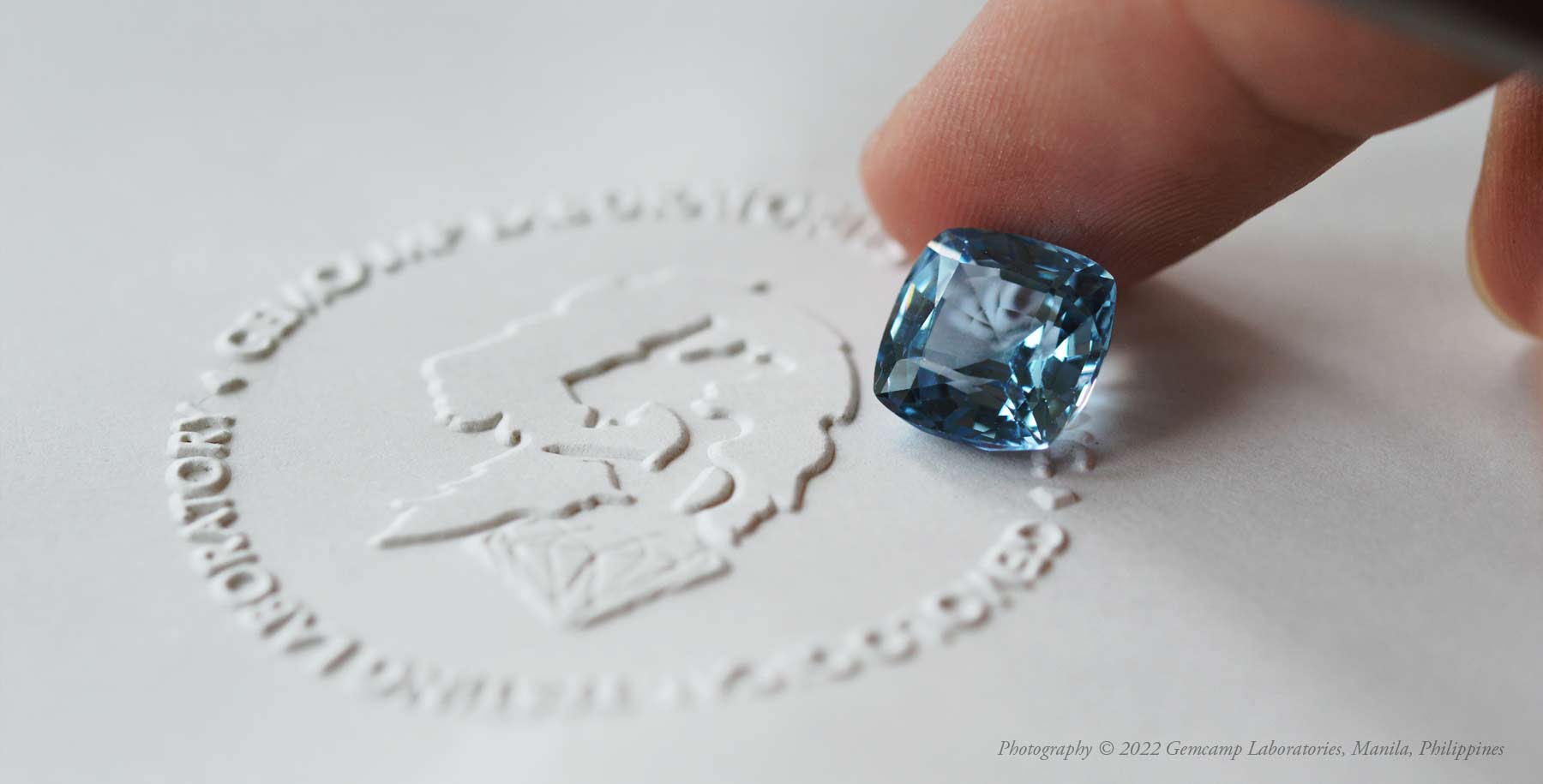 Pristime faceted aquamarine specimen being examined at Gemcamp Laboratories