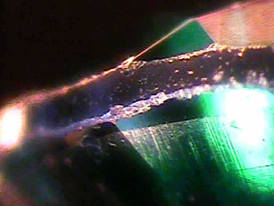 Microscopic videw of a green assembled triplet imitation gemstone