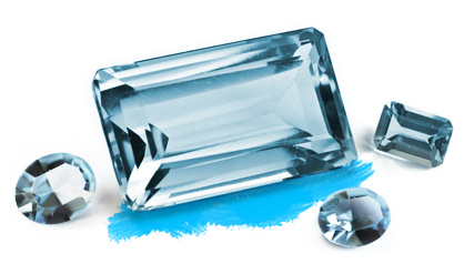 A light blue faceted gemstone surrounded by smaller aquamarine specimens