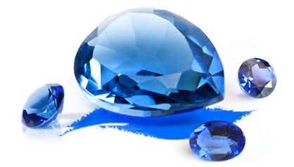 A blue faceted gemstone surrounded by smaller sapphire specimens