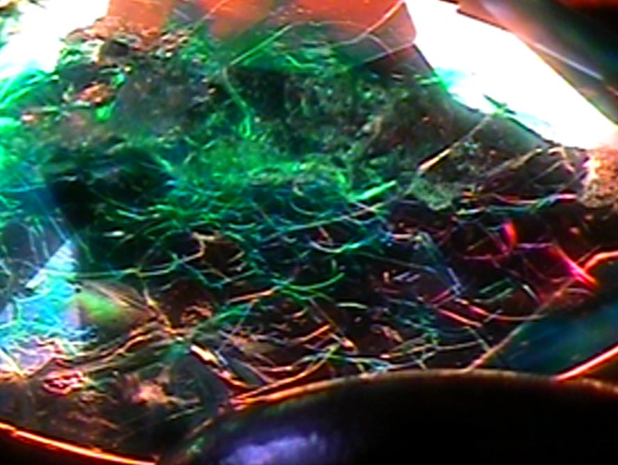 Microscopic view of a green-dyed quench-crackled quartz