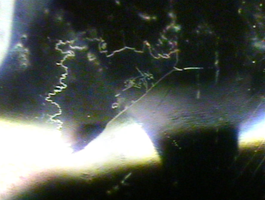 Mirror-like liquid inclusions inside a tourmaline gemstone